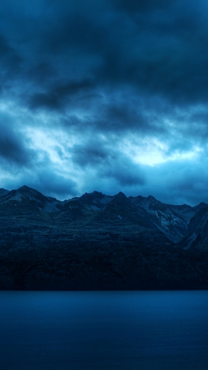 Black and White Mountains Under Gray Clouds. Wallpaper in 720x1280 Resolution