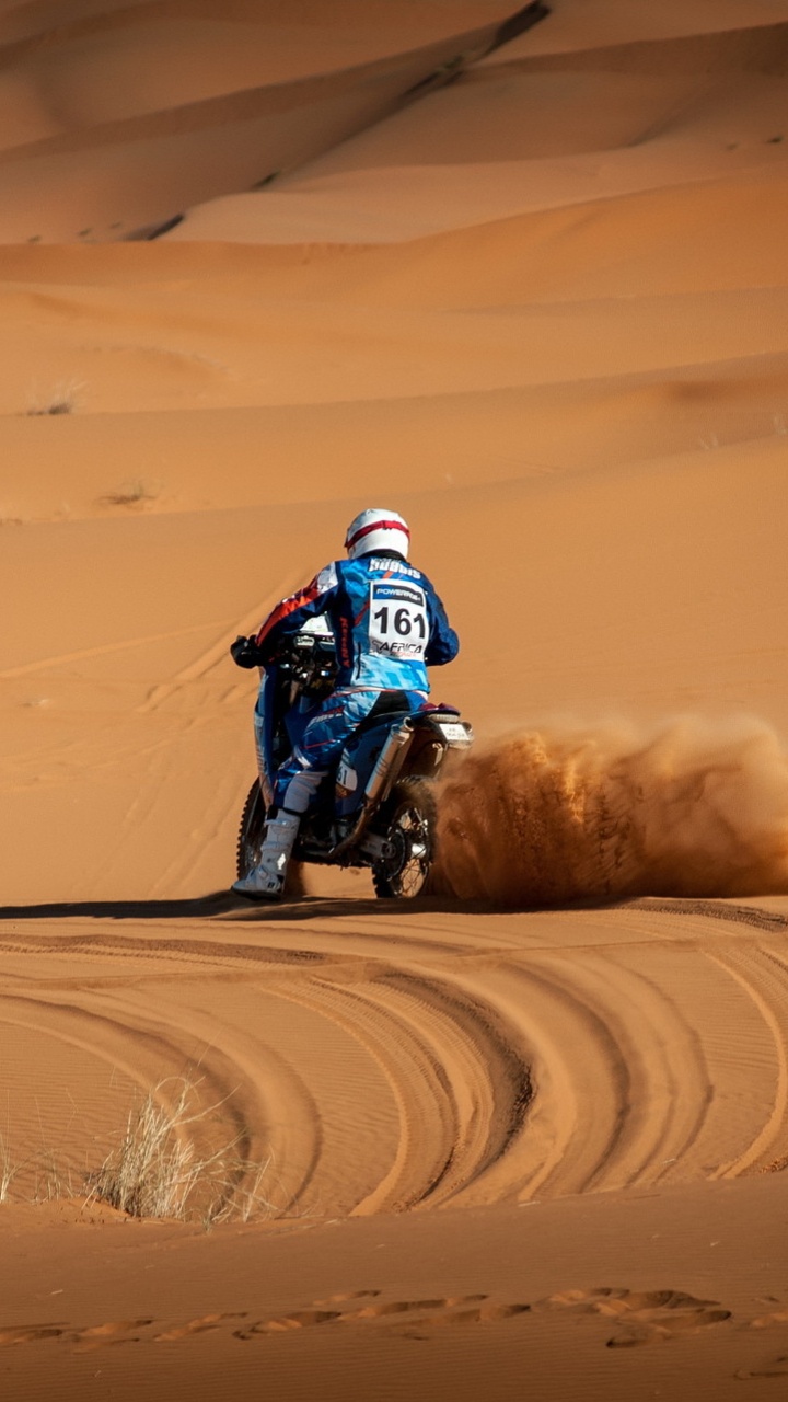Man Riding Motocross Dirt Bike on Desert During Daytime. Wallpaper in 720x1280 Resolution