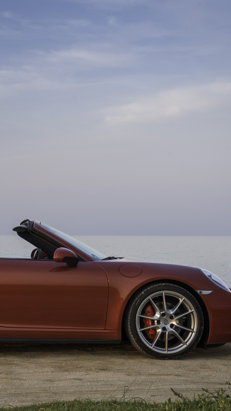 Brown Convertible Coupe on Green Grass Field Under White Clouds During Daytime. Wallpaper in 750x1334 Resolution