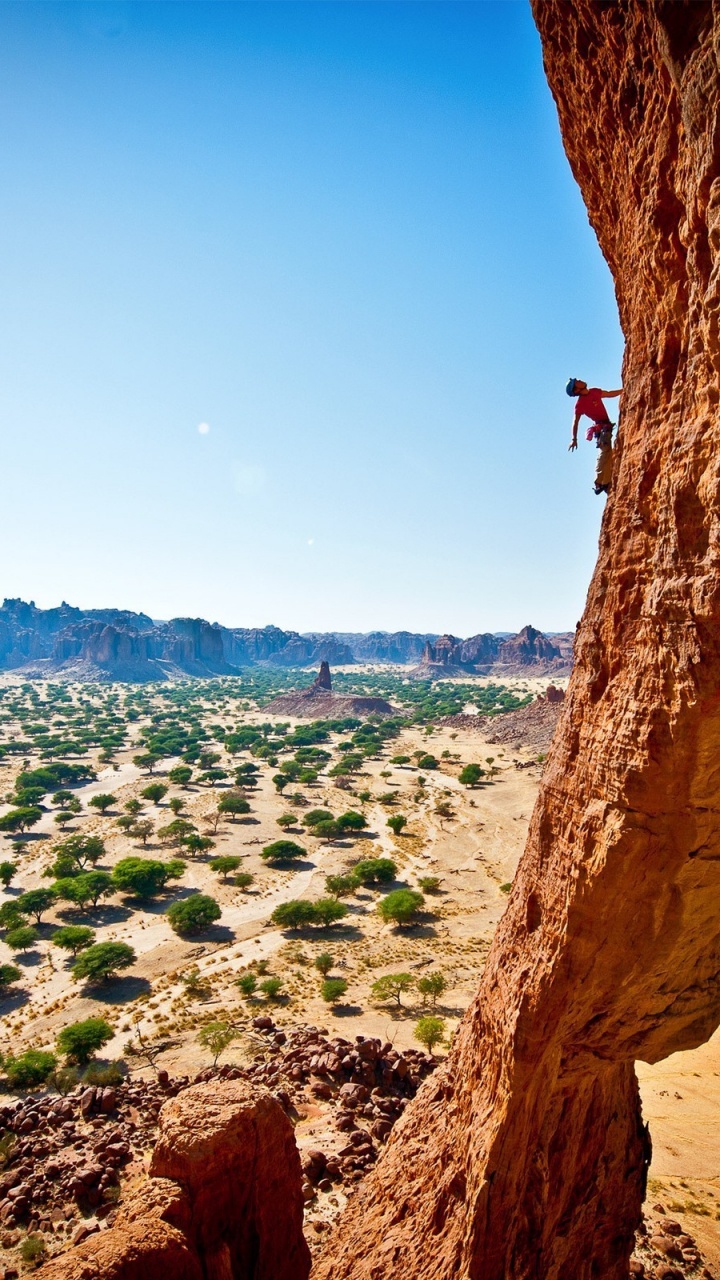Person Standing on Brown Rock Formation During Daytime. Wallpaper in 720x1280 Resolution