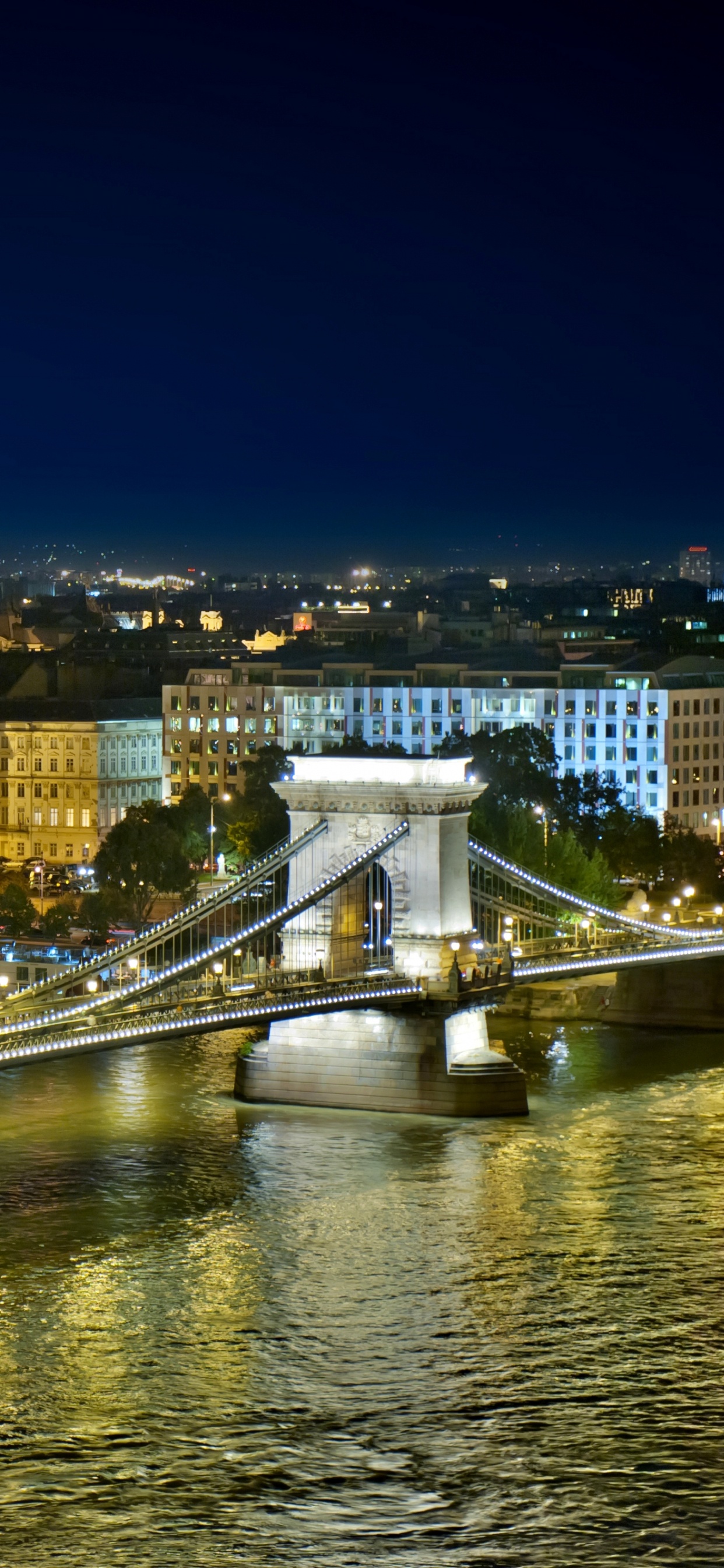 Bridge Over River During Night Time. Wallpaper in 1242x2688 Resolution