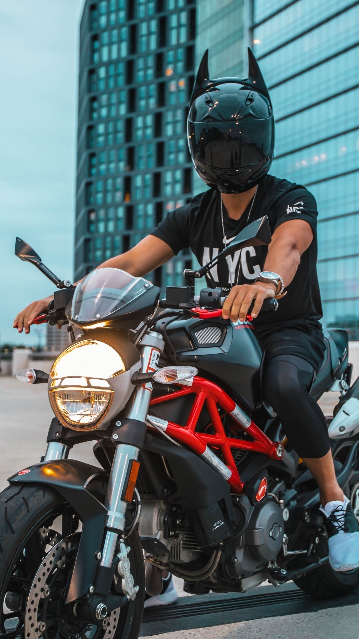 Man in Black Helmet Riding on Orange and Black Motorcycle. Wallpaper in 720x1280 Resolution