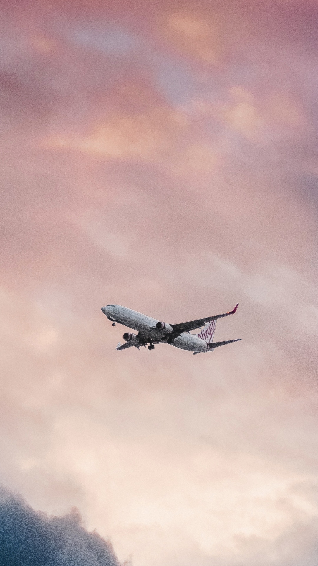 White Airplane Flying Over Clouds. Wallpaper in 1080x1920 Resolution