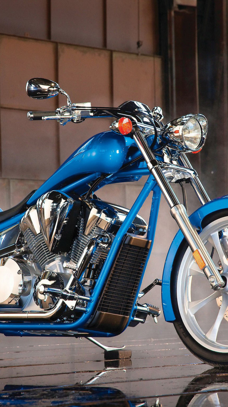 Blue and Silver Cruiser Motorcycle Parked Beside Brown Brick Wall. Wallpaper in 750x1334 Resolution