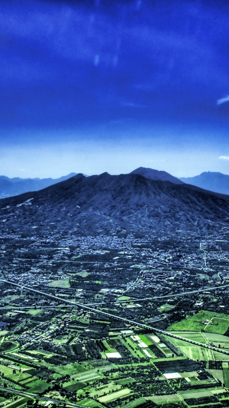 Green Mountain Under Blue Sky During Daytime. Wallpaper in 750x1334 Resolution