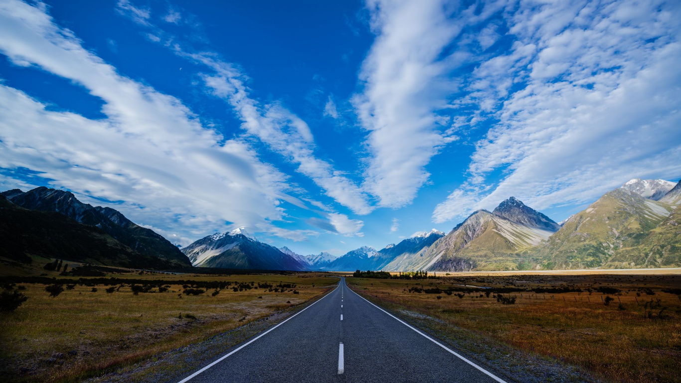 Gray Concrete Road Near Mountain Under Blue Sky During Daytime. Wallpaper in 1366x768 Resolution