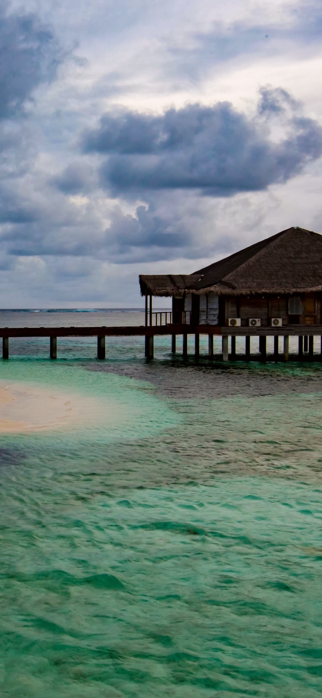 Brown Wooden Dock on Blue Sea Under Blue Sky and White Clouds During Daytime. Wallpaper in 1125x2436 Resolution