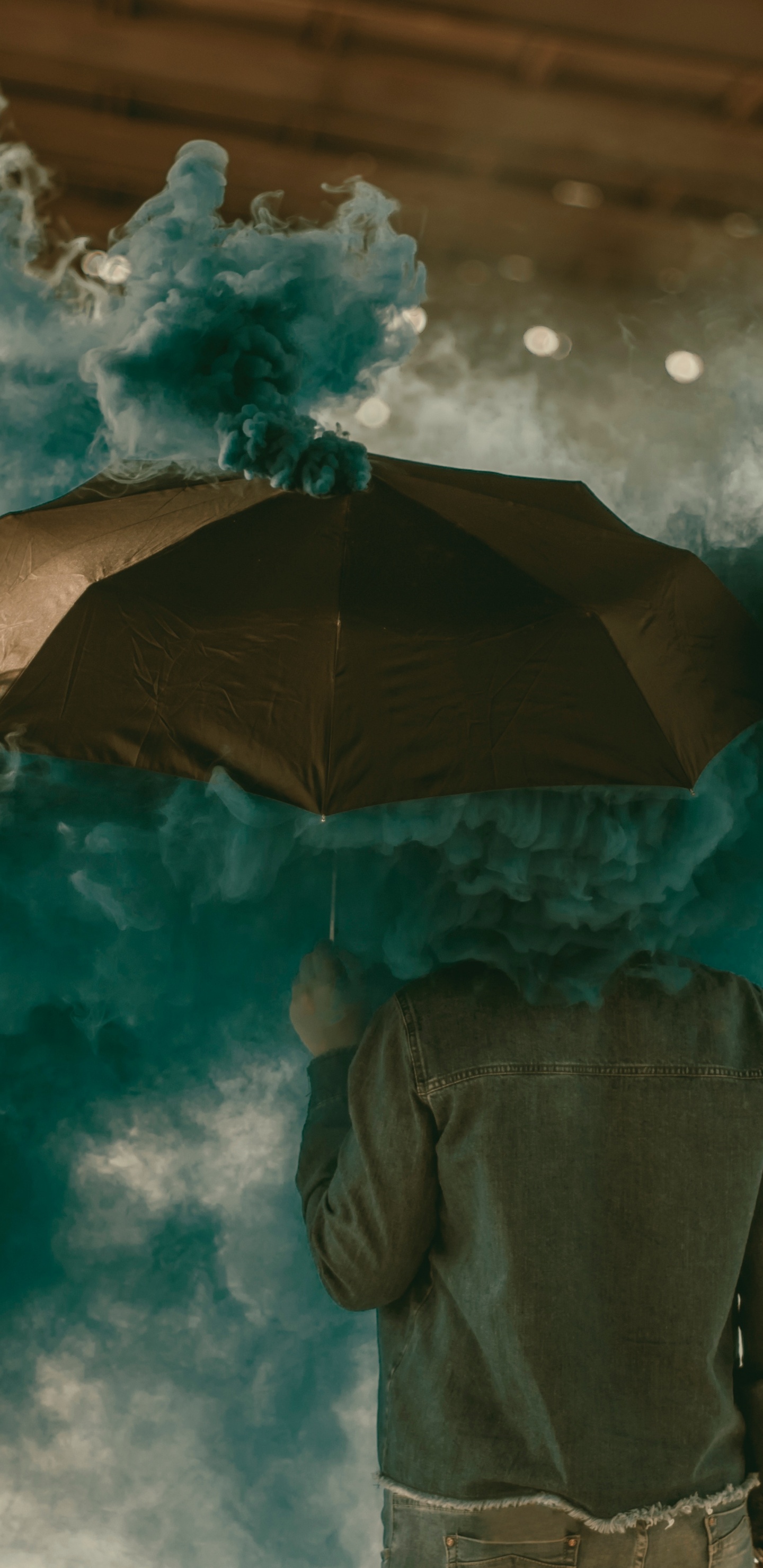 Person in Brown Jacket Holding Umbrella Under White Clouds. Wallpaper in 1440x2960 Resolution