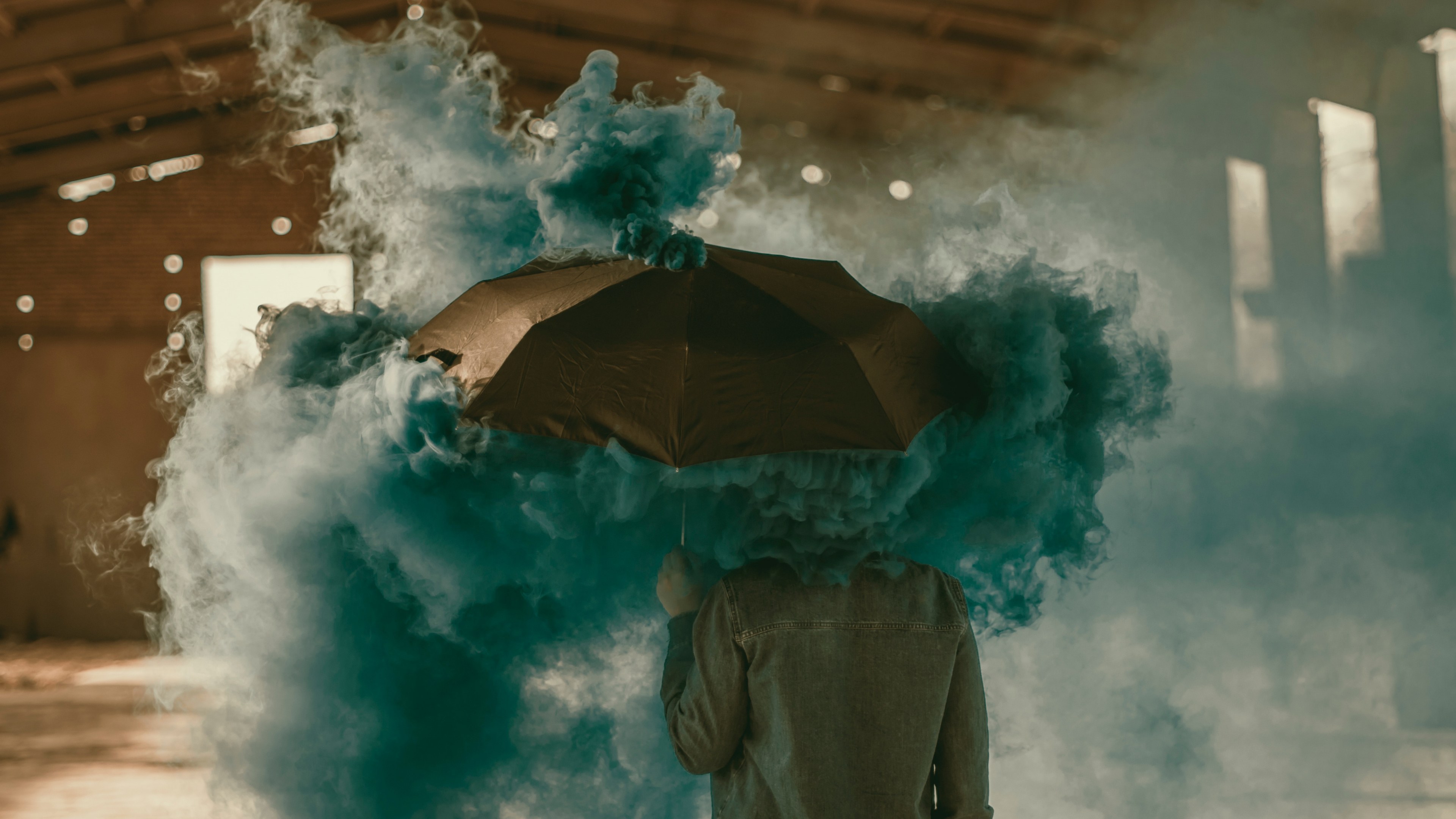 Person in Brown Jacket Holding Umbrella Under White Clouds. Wallpaper in 3840x2160 Resolution