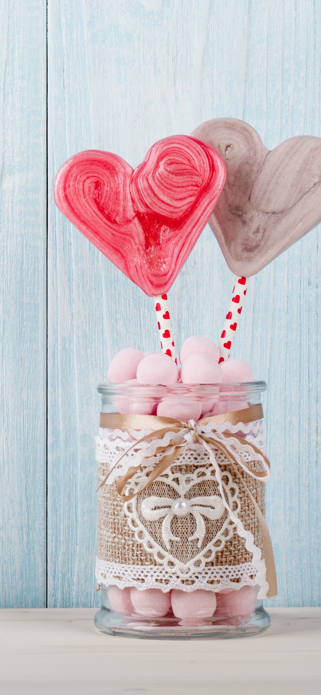 Red Heart Balloon on Brown Wooden Table. Wallpaper in 1125x2436 Resolution