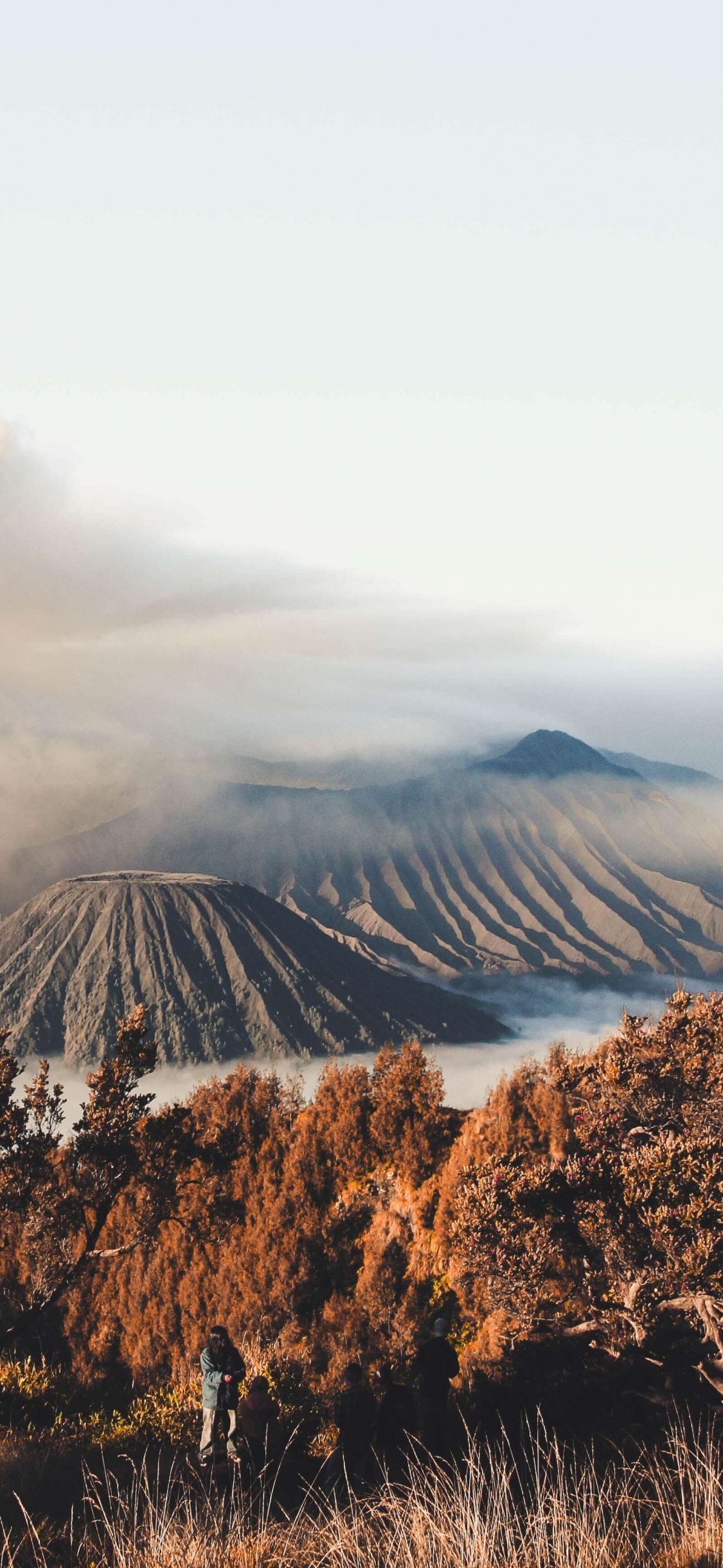 Brown and Green Mountain Under White Clouds During Daytime. Wallpaper in 1125x2436 Resolution