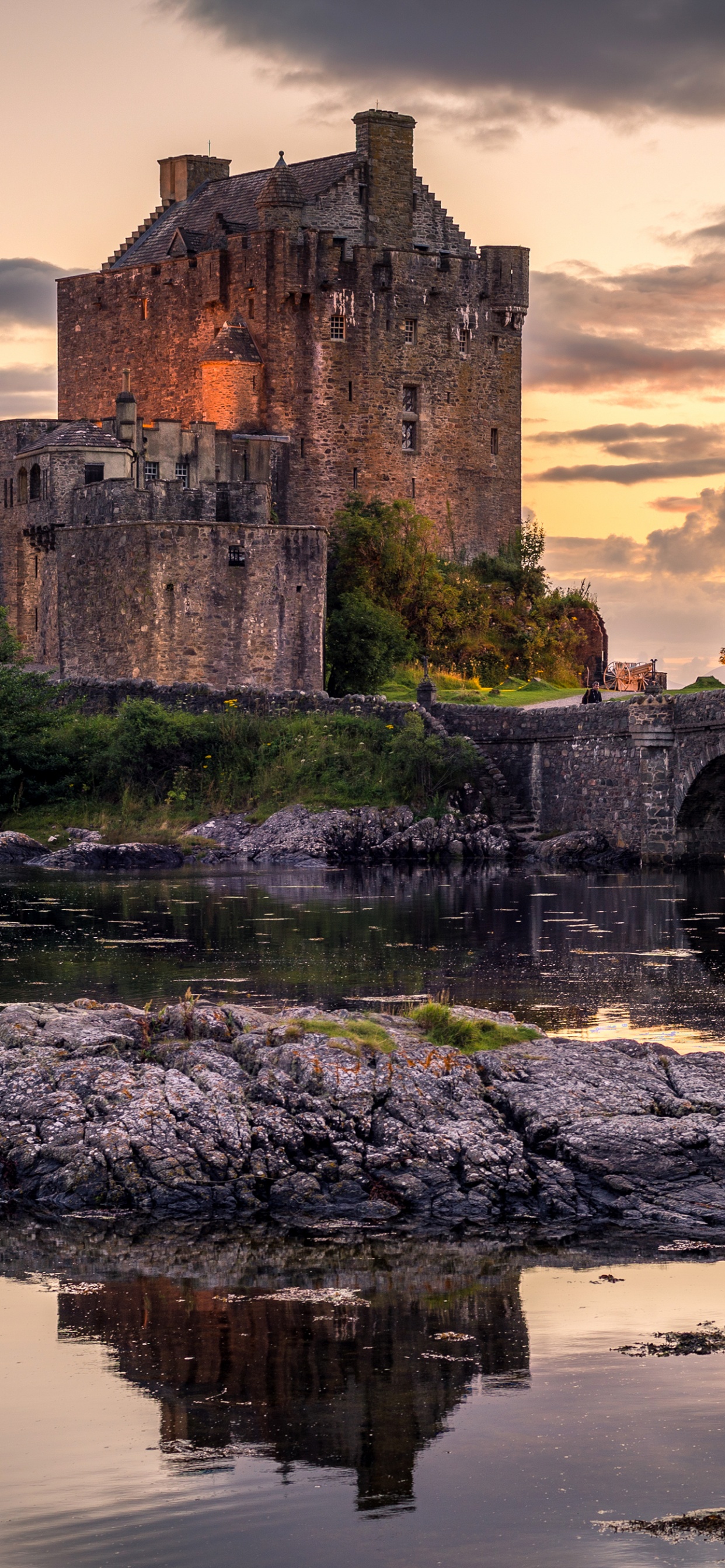 Gray Concrete Building on Body of Water During Sunset. Wallpaper in 1242x2688 Resolution
