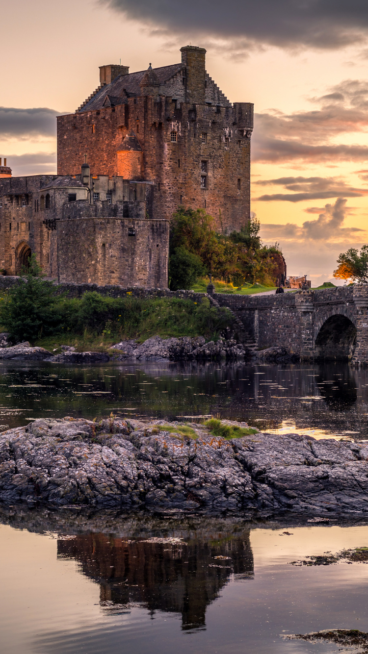 Gray Concrete Building on Body of Water During Sunset. Wallpaper in 750x1334 Resolution