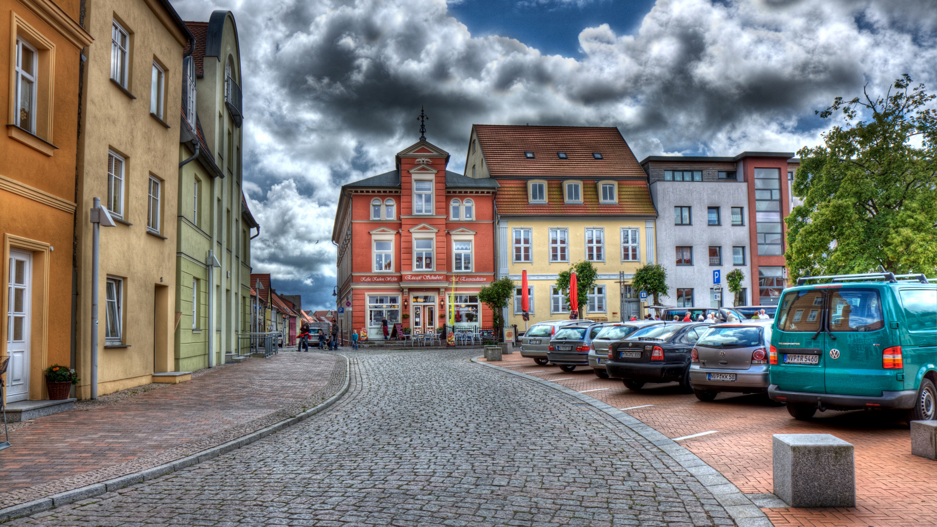 Cars Parked Beside Brown Concrete Building Under Cloudy Sky During Daytime. Wallpaper in 1920x1080 Resolution