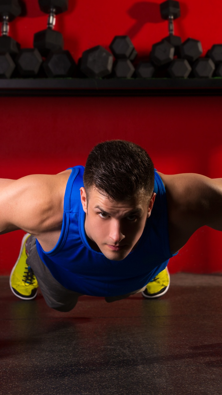 Man in Blue Tank Top and Black Shorts Doing Push Up. Wallpaper in 720x1280 Resolution