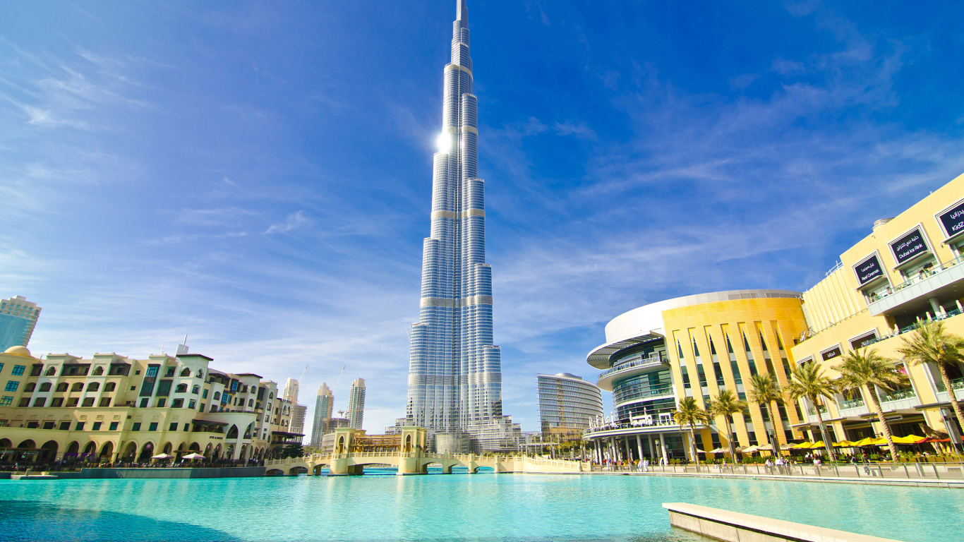 White and Blue High Rise Building Near Body of Water During Daytime. Wallpaper in 1366x768 Resolution
