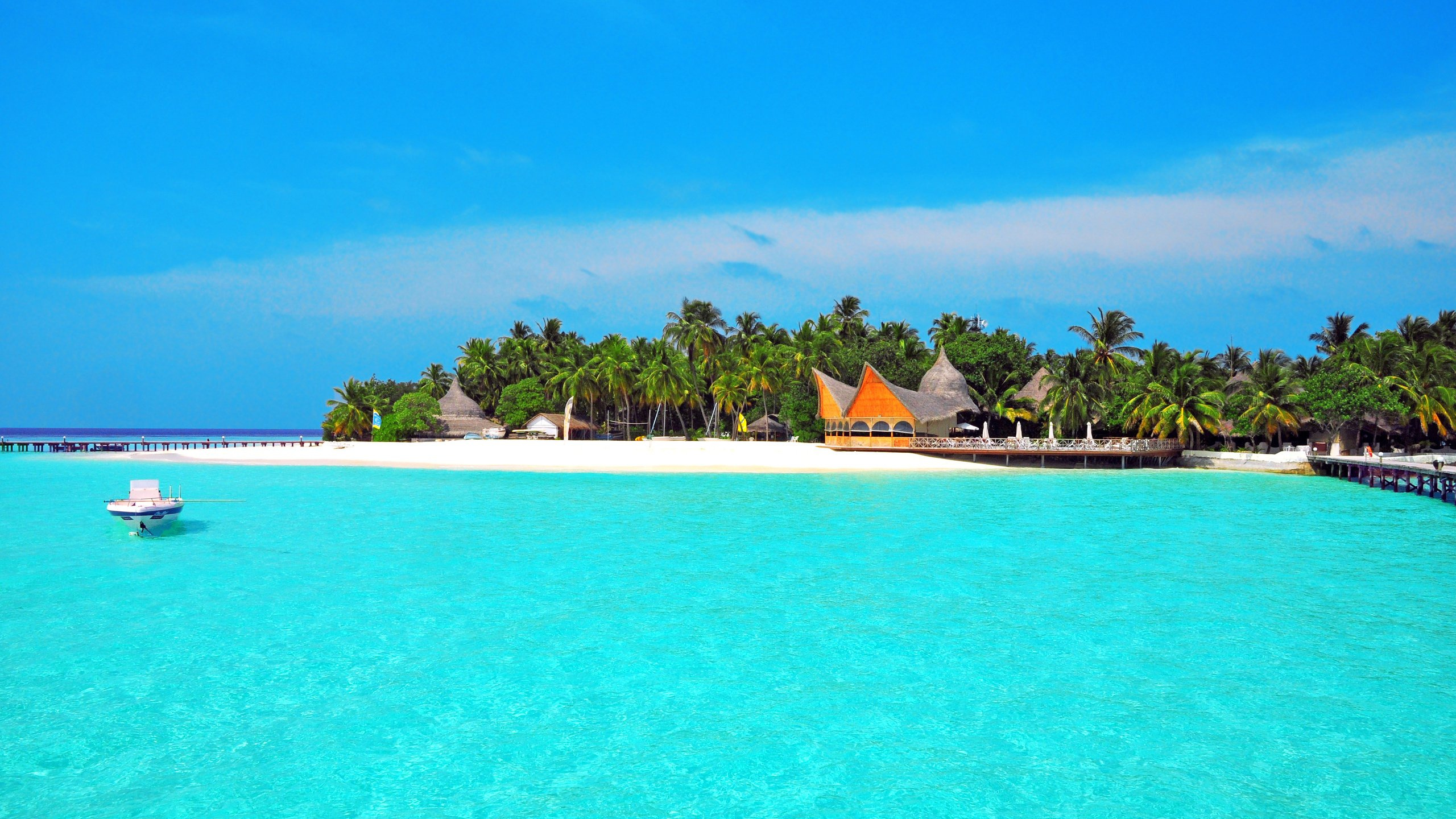 White and Brown Wooden Boat on Blue Sea Under Blue Sky During Daytime. Wallpaper in 2560x1440 Resolution