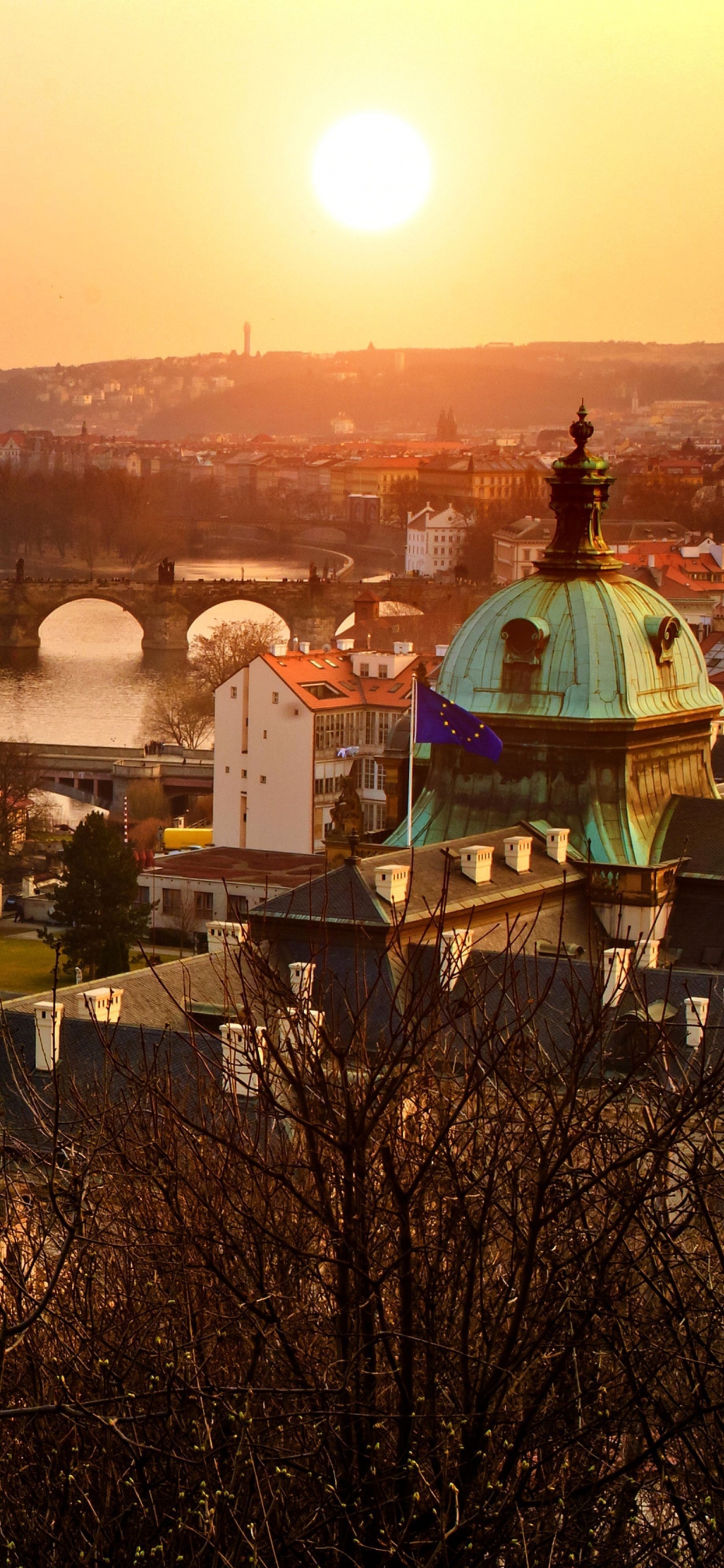 Brown Concrete Bridge Over River During Sunset. Wallpaper in 1242x2688 Resolution