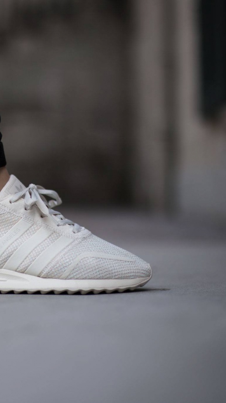 Person in Black Denim Jeans and White Nike Sneakers. Wallpaper in 720x1280 Resolution