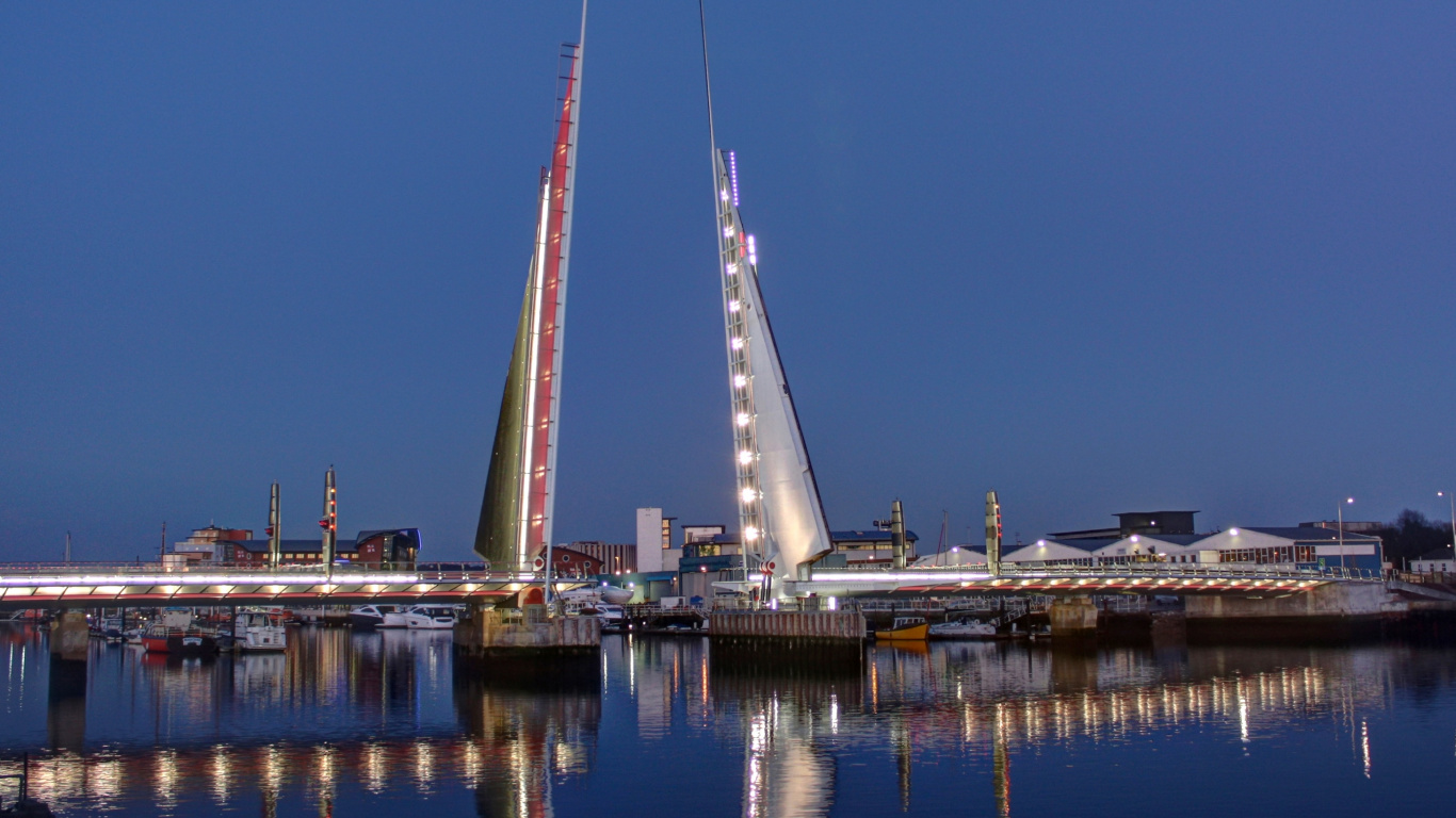 White Bridge Over Body of Water During Night Time. Wallpaper in 1366x768 Resolution