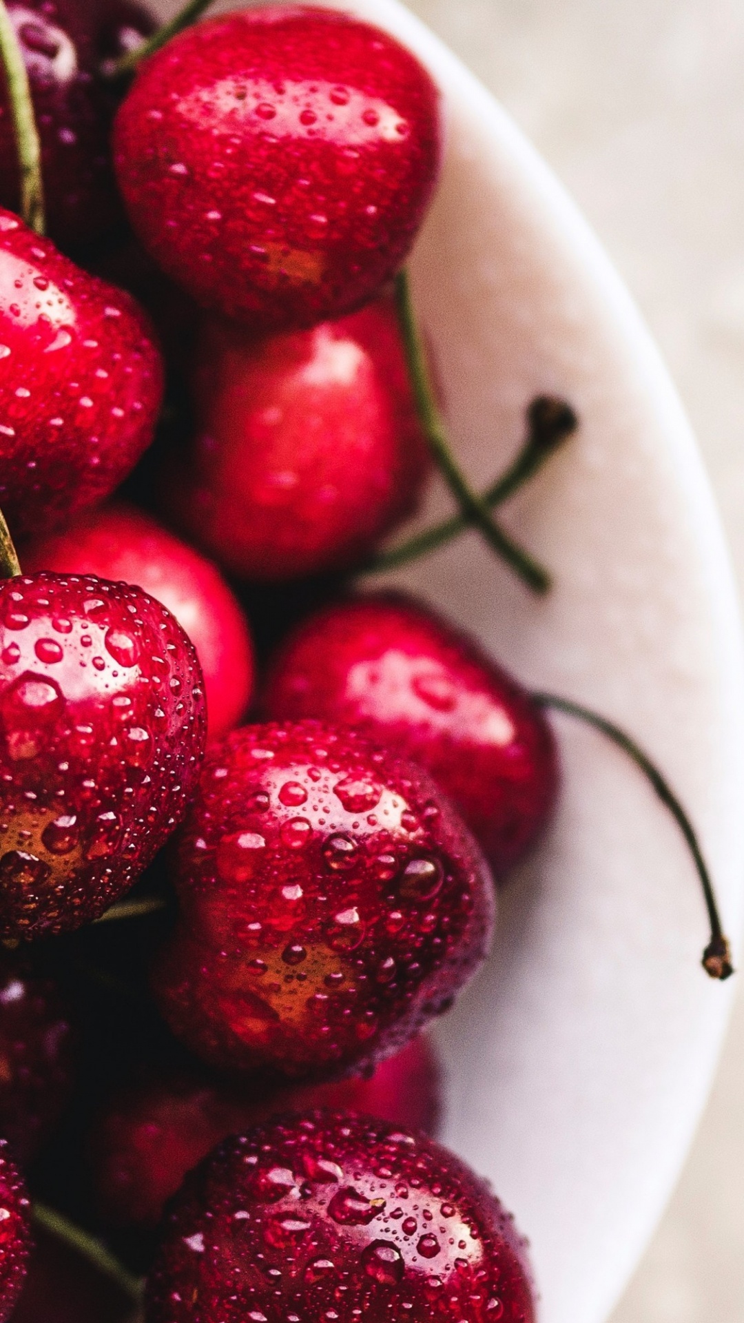 Red Round Fruits on White Textile. Wallpaper in 1080x1920 Resolution