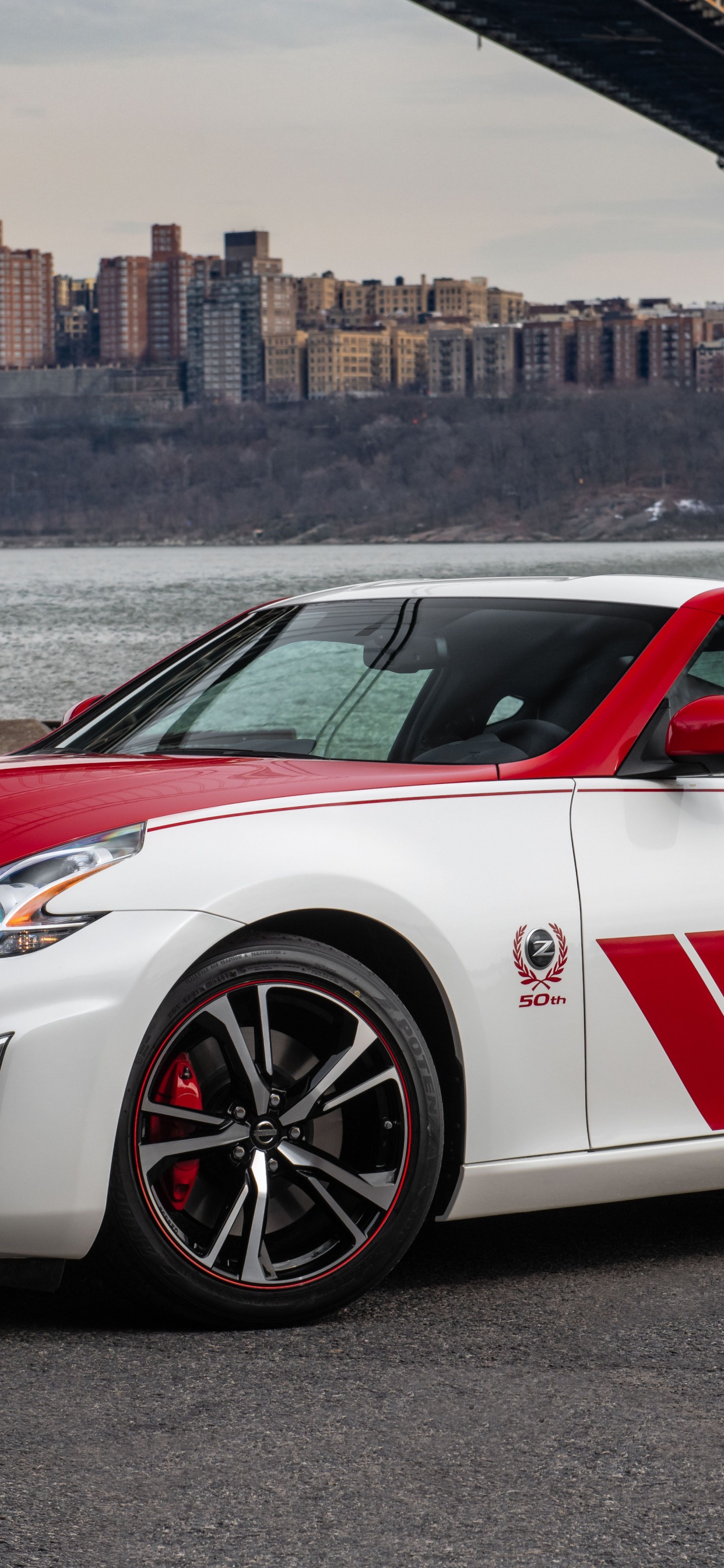 White and Red Porsche 911 Parked on Gray Pavement Near Body of Water During Daytime. Wallpaper in 1242x2688 Resolution