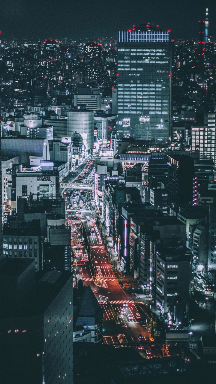 Stadt Mit Hochhäusern Während Der Nacht. Wallpaper in 720x1280 Resolution