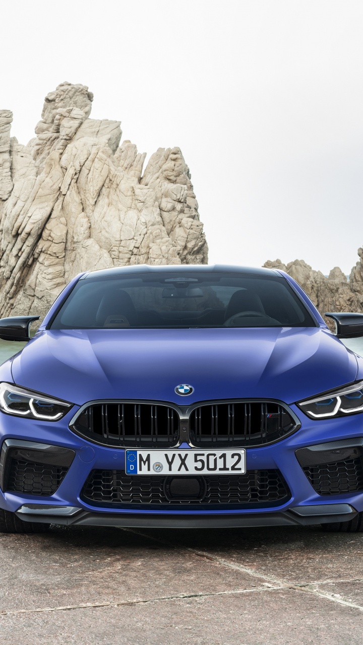 Blue Bmw Car Parked Near Brown Rock Formation During Daytime. Wallpaper in 720x1280 Resolution