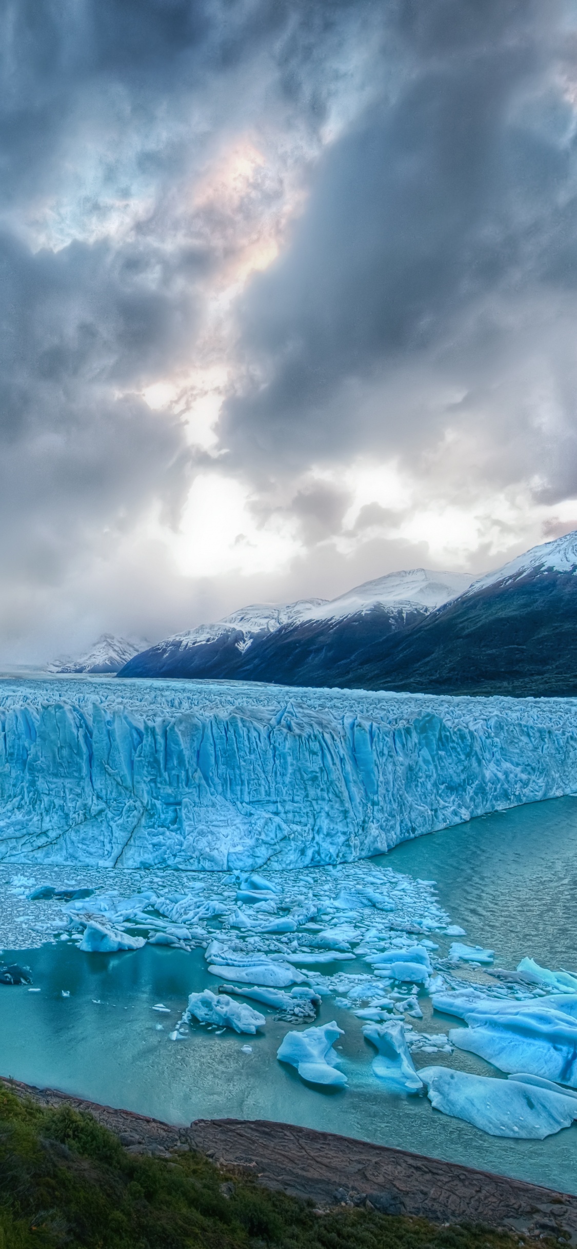 Grüne Bäume in Der Nähe Des Sees Unter Bewölktem Himmel Tagsüber. Wallpaper in 1125x2436 Resolution