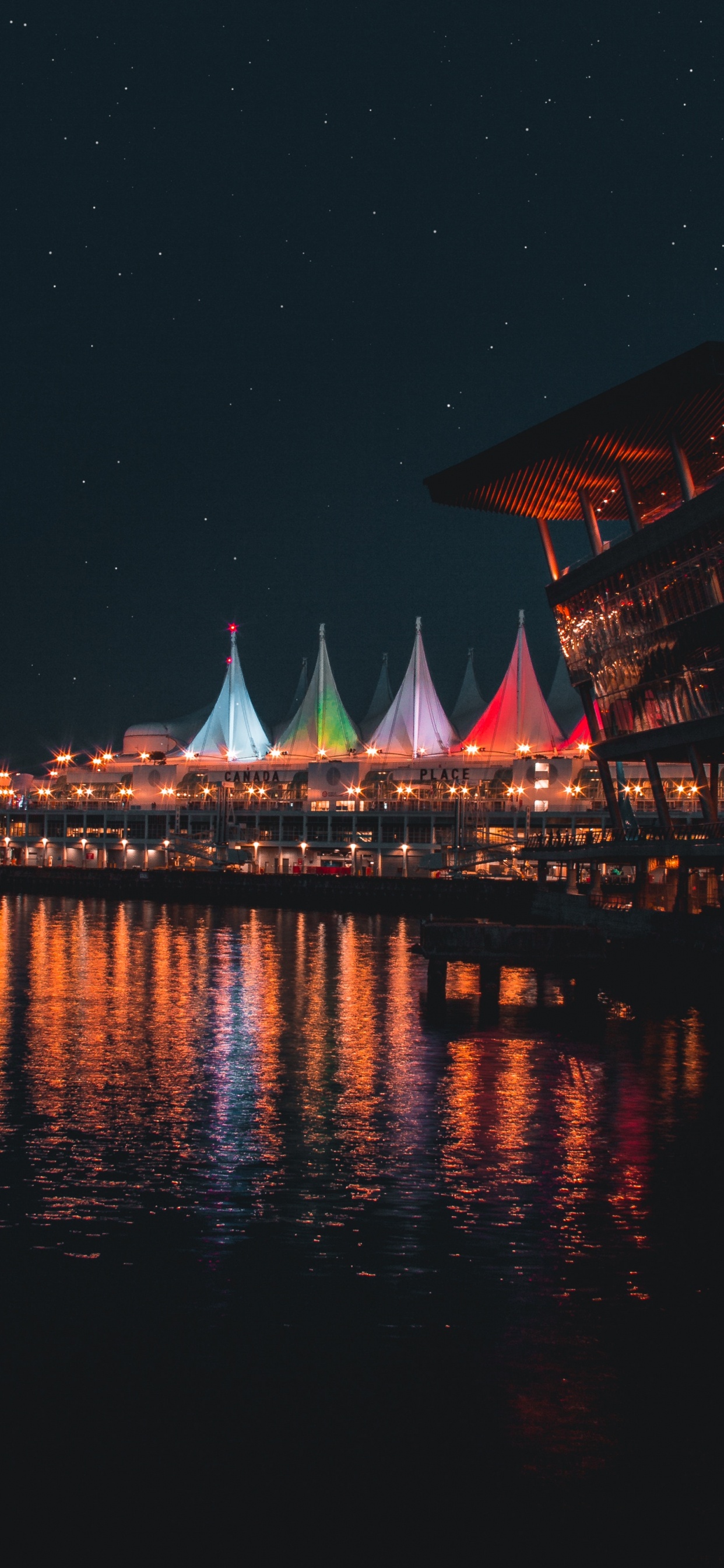 Brown and White Building Near Body of Water During Night Time. Wallpaper in 1242x2688 Resolution
