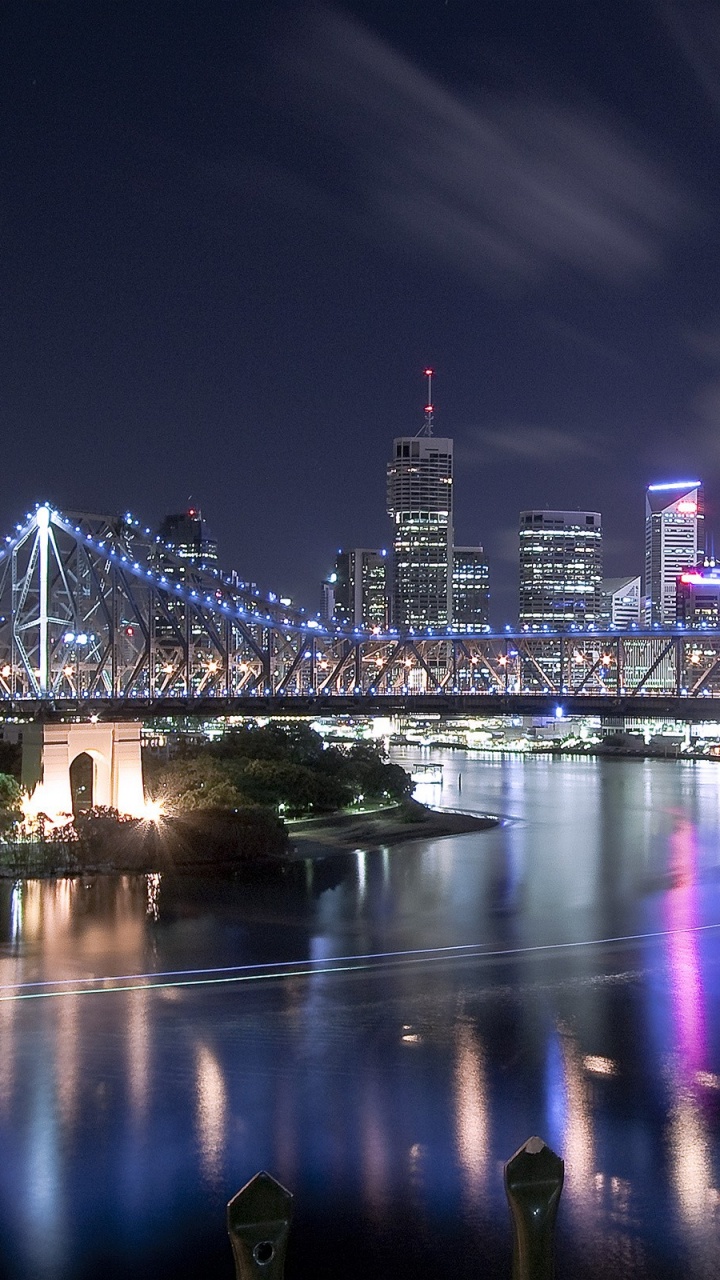 People Sitting on Bench Near Bridge During Night Time. Wallpaper in 720x1280 Resolution