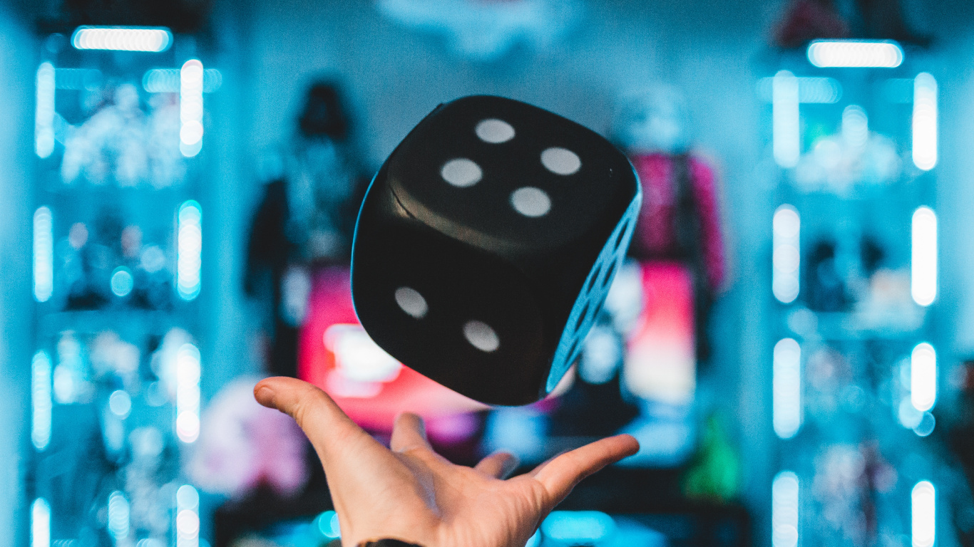Person Holding Purple and White Polka Dot Dice. Wallpaper in 1366x768 Resolution