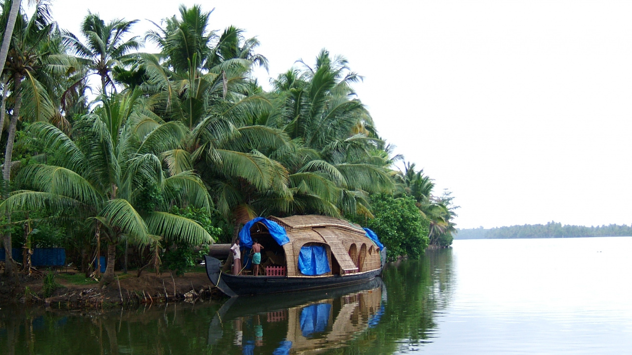 Man in Blue Shirt Riding on Brown Boat on Lake During Daytime. Wallpaper in 1280x720 Resolution