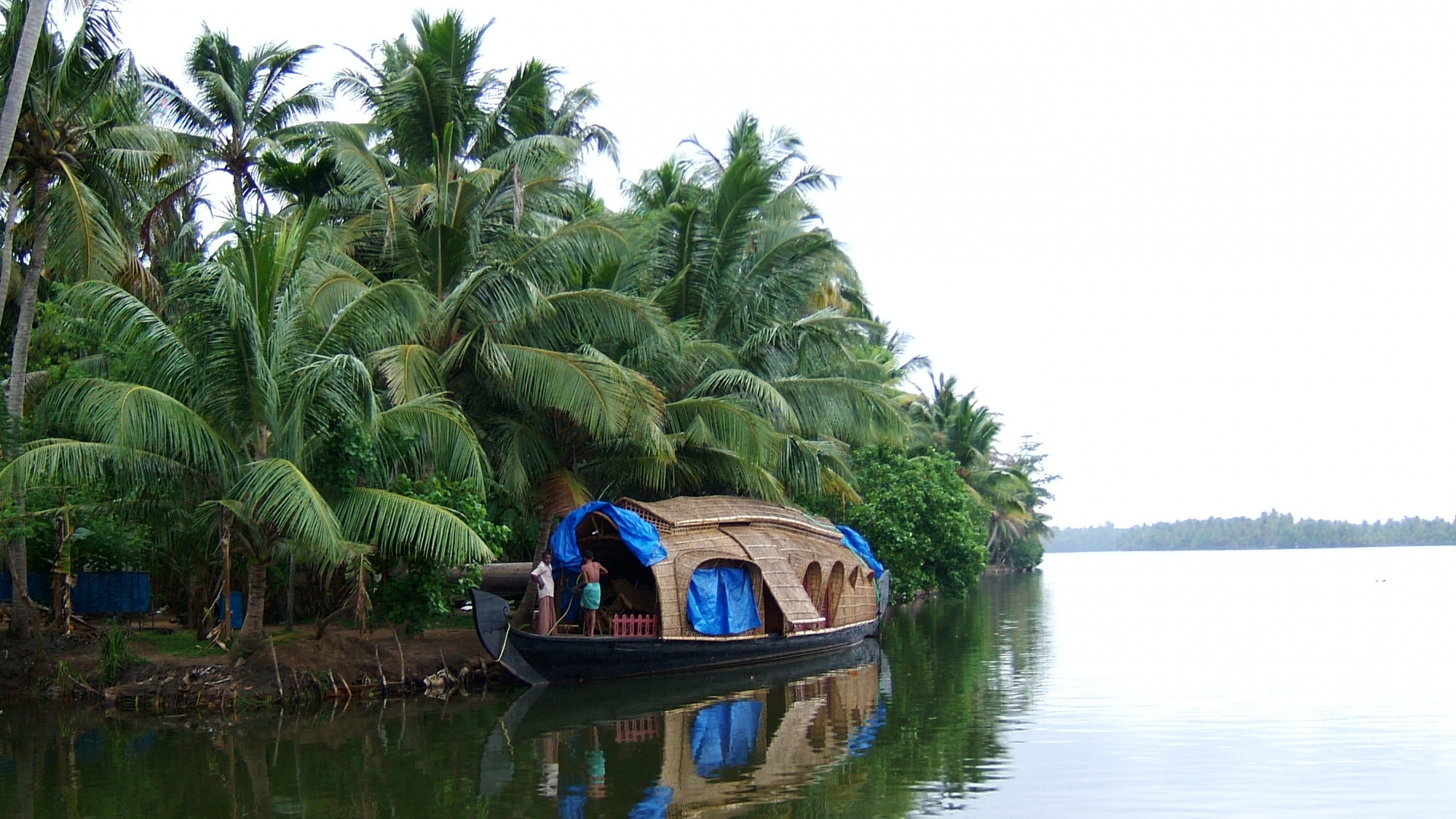 Man in Blue Shirt Riding on Brown Boat on Lake During Daytime. Wallpaper in 1920x1080 Resolution