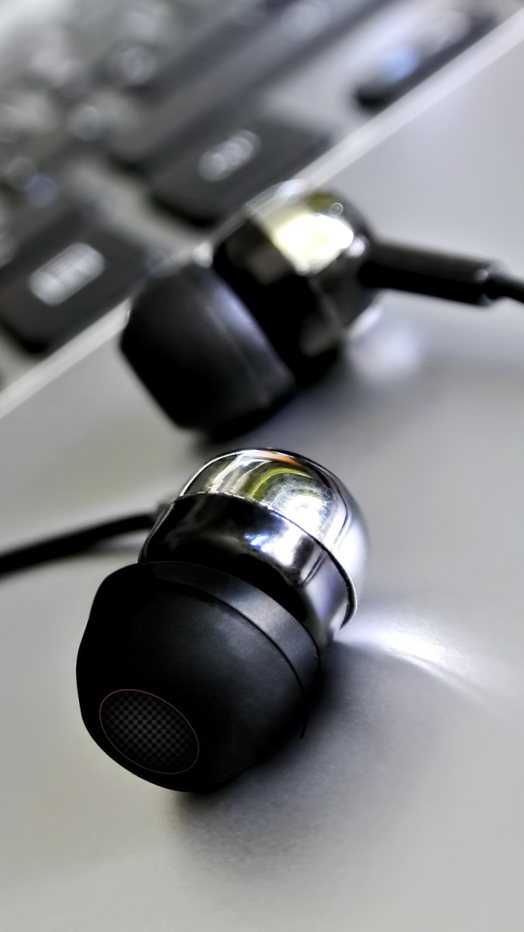 Black and Silver Headphones on White Table. Wallpaper in 750x1334 Resolution