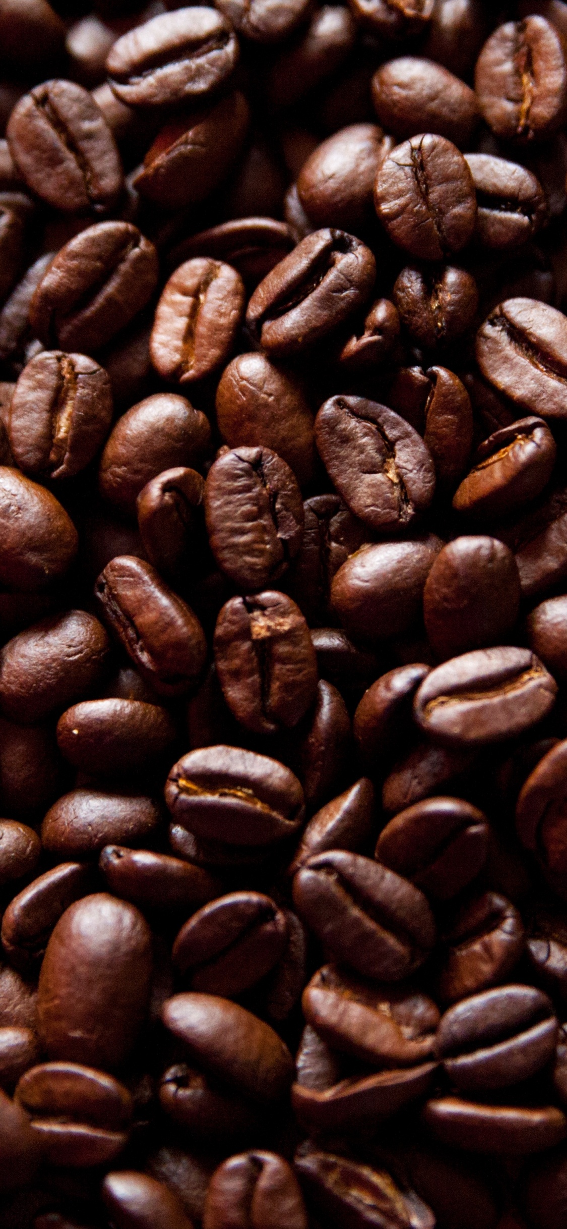 Brown Coffee Beans on Brown Wooden Table. Wallpaper in 1125x2436 Resolution