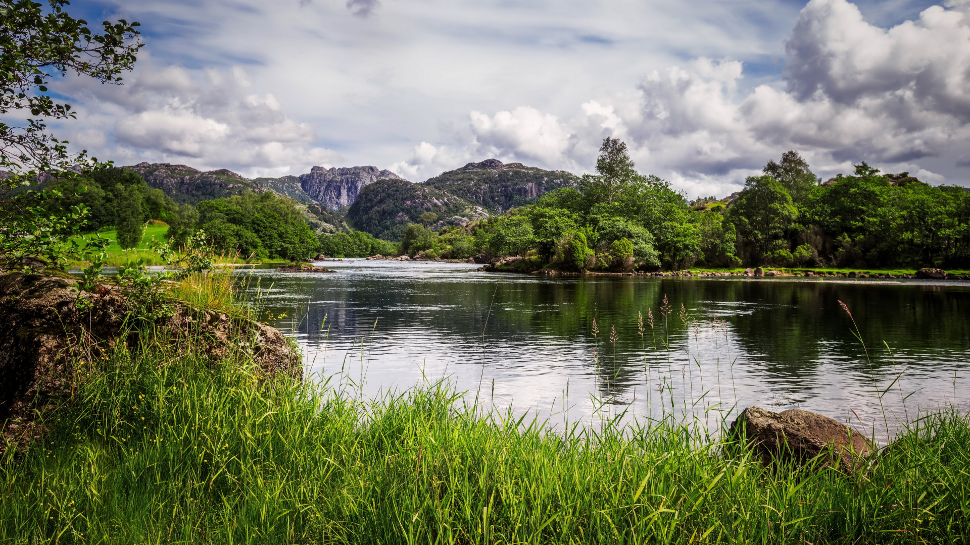 Green Grass Near Lake and Mountain Under White Clouds During Daytime. Wallpaper in 1920x1080 Resolution