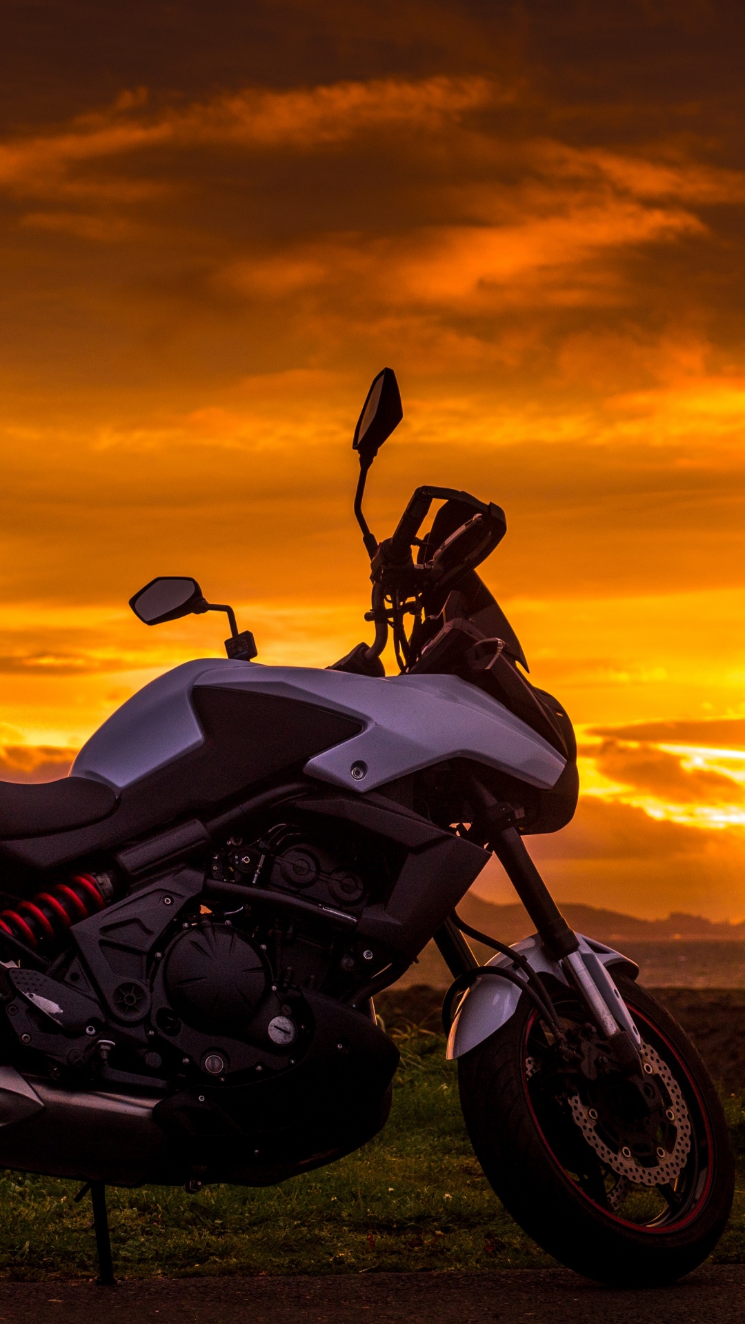 Black and White Sports Bike on Green Grass Field During Sunset. Wallpaper in 1080x1920 Resolution