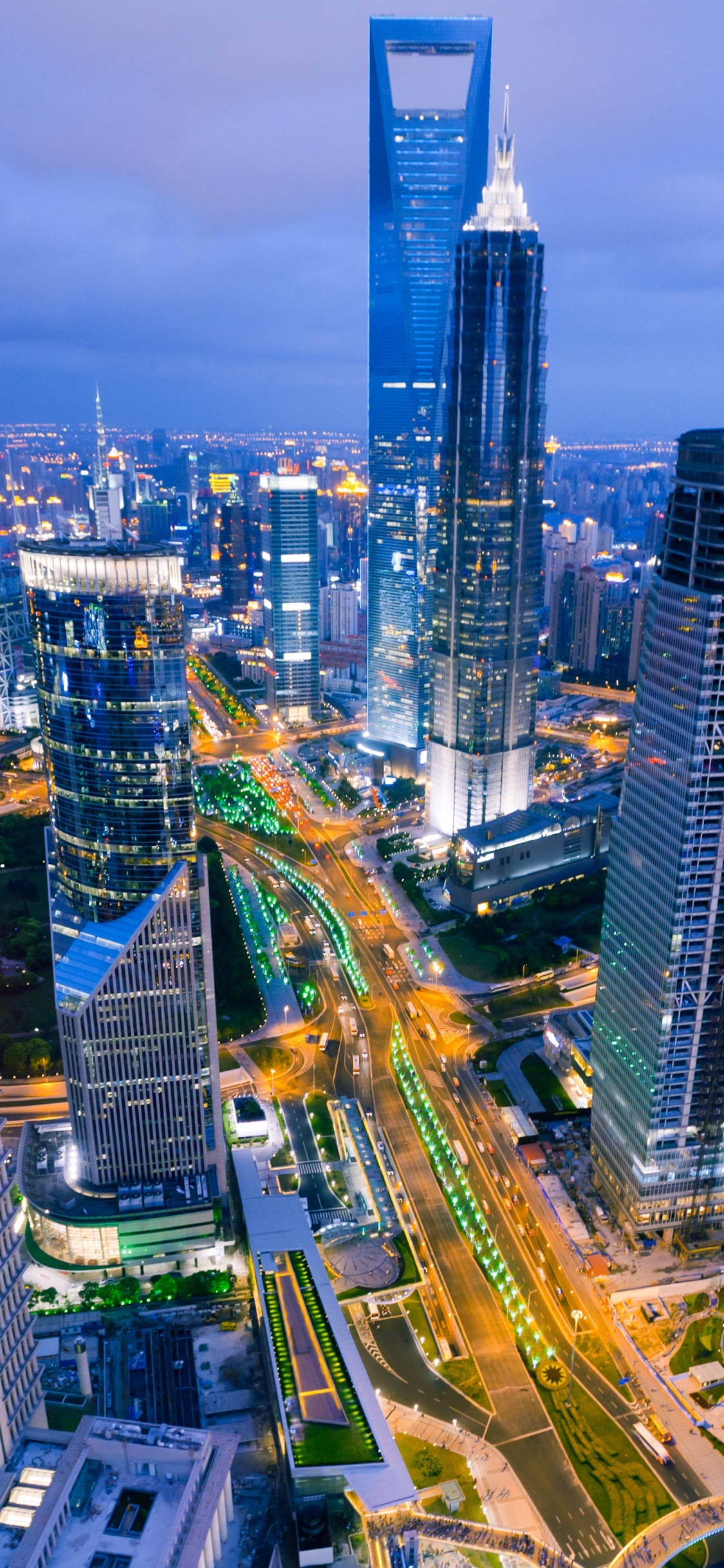 Aerial View of City Buildings During Night Time. Wallpaper in 1125x2436 Resolution