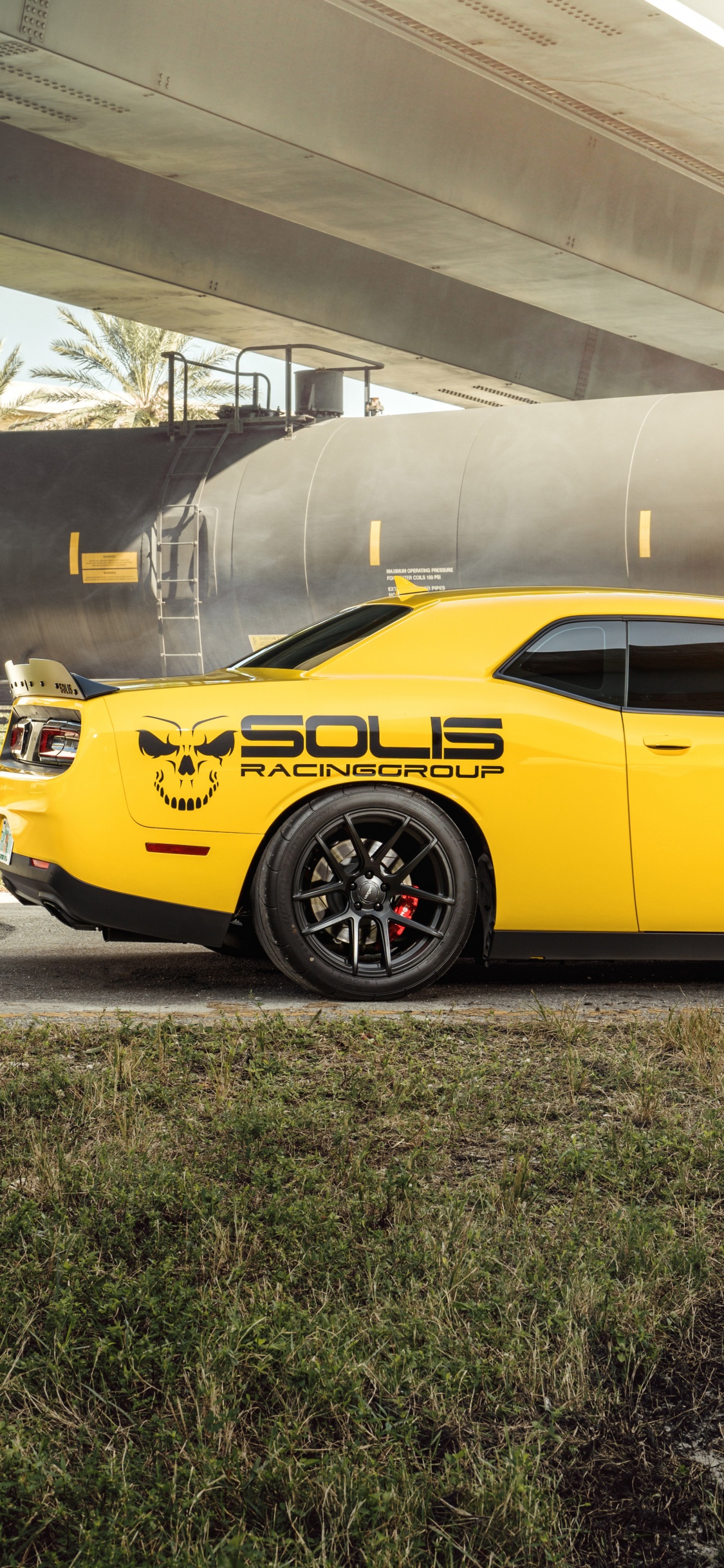 Yellow Coupe Parked on Gray Concrete Ground. Wallpaper in 1125x2436 Resolution