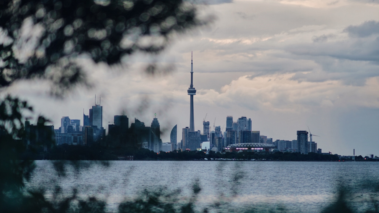 City Skyline Across Body of Water During Daytime. Wallpaper in 1280x720 Resolution