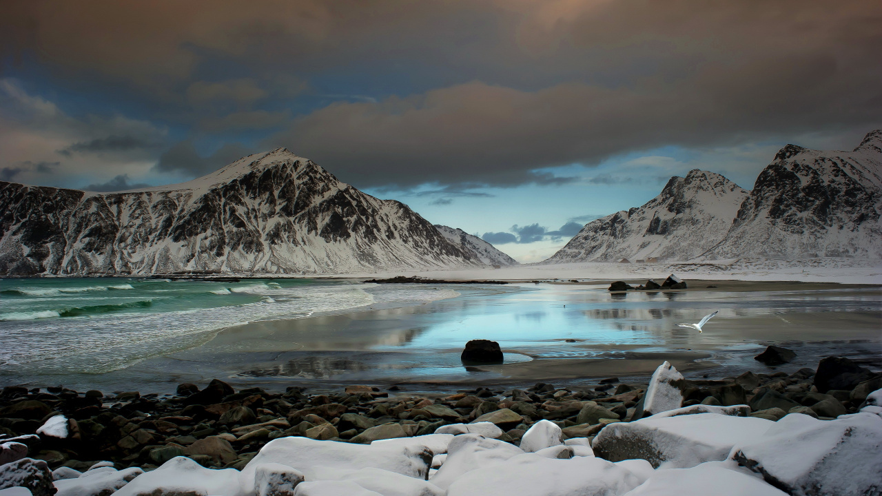 Rocky Shore Near Mountain Under Cloudy Sky During Daytime. Wallpaper in 1280x720 Resolution