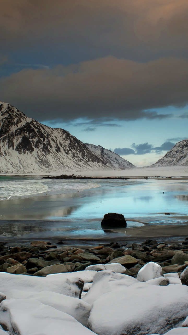 Rocky Shore Near Mountain Under Cloudy Sky During Daytime. Wallpaper in 720x1280 Resolution
