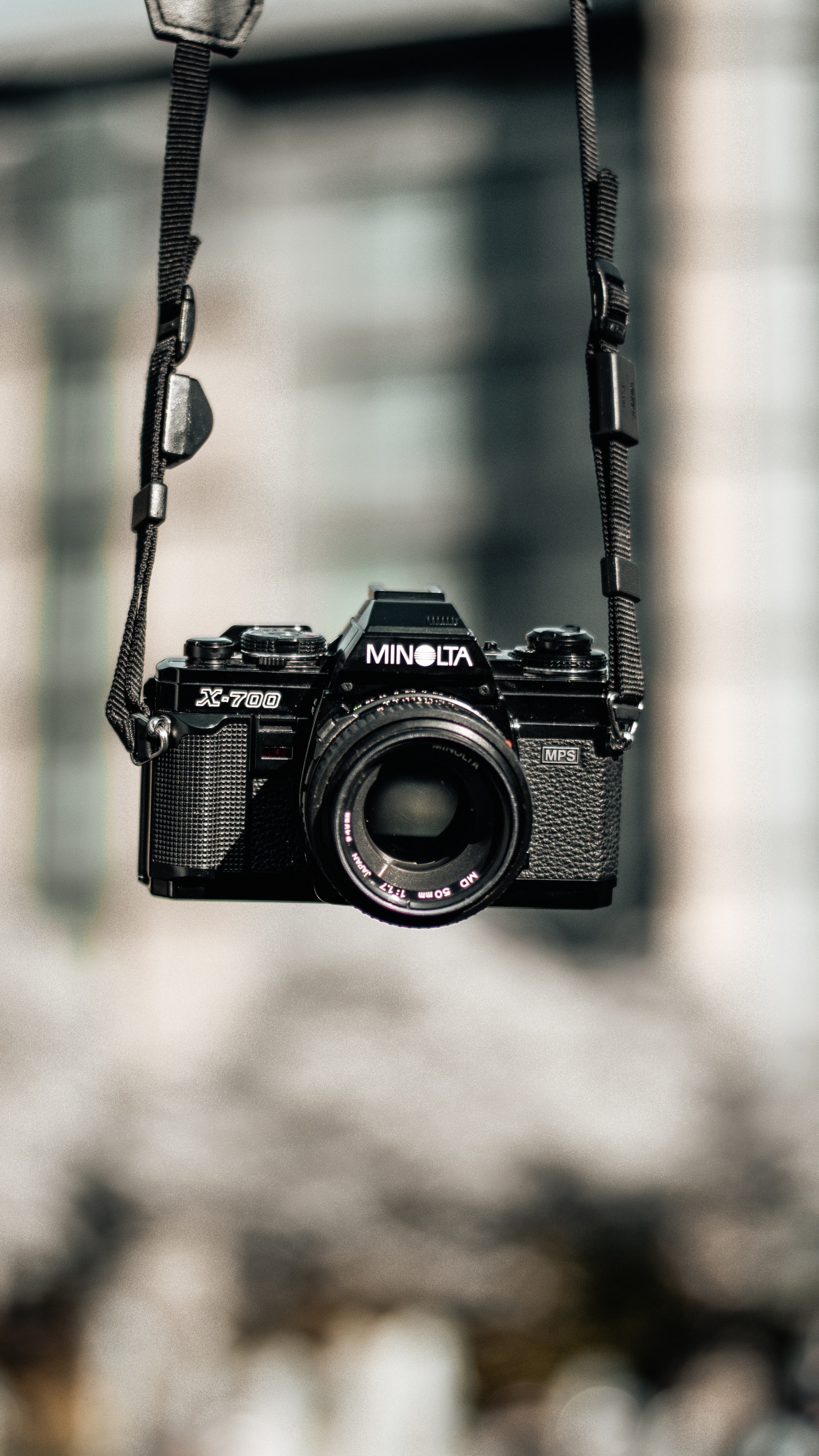 Black Nikon Dslr Camera Hanging on Black Metal Wire. Wallpaper in 1440x2560 Resolution
