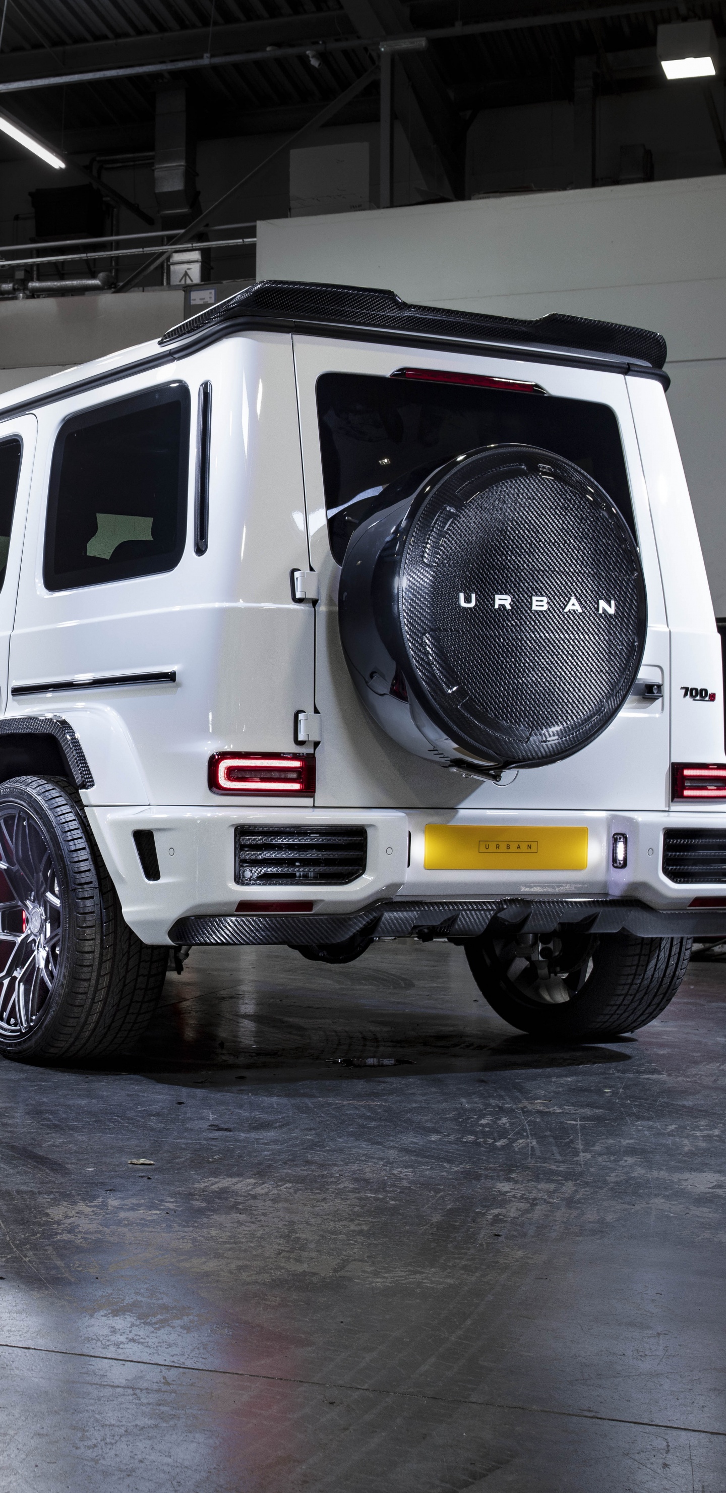 White Suv Parked in Front of Blue Building. Wallpaper in 1440x2960 Resolution