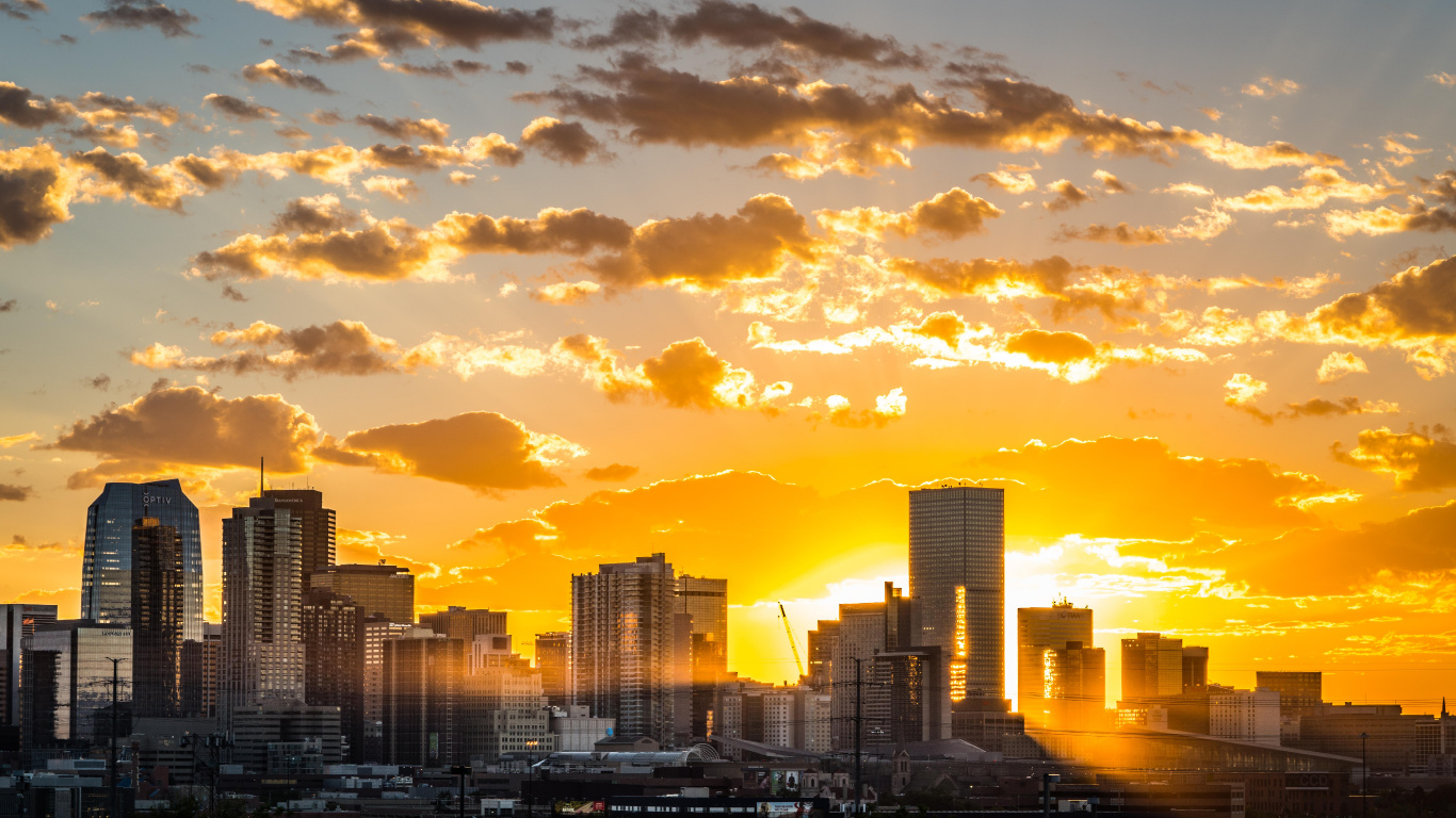 City Skyline Under Cloudy Sky During Sunset. Wallpaper in 1366x768 Resolution