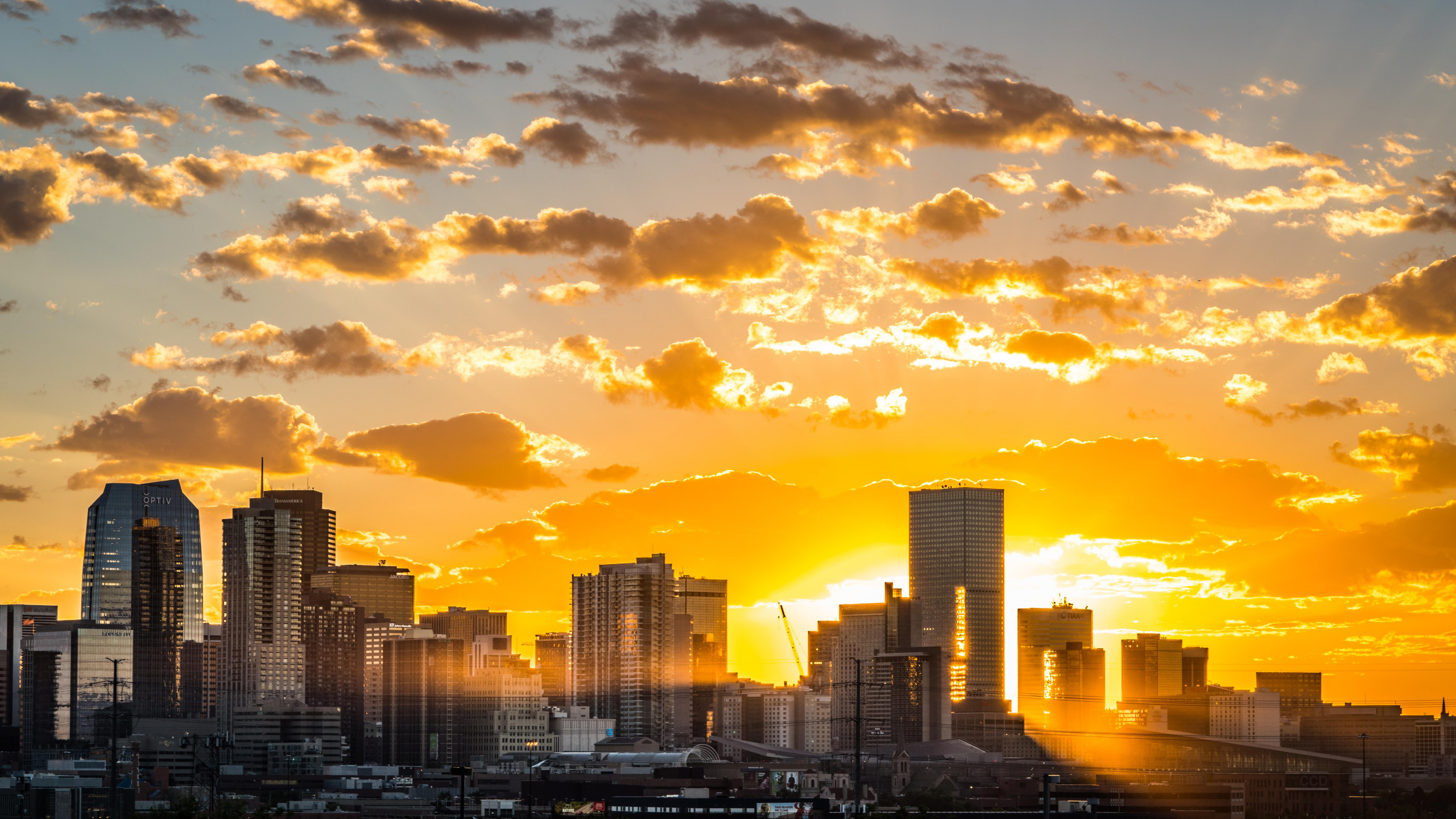 City Skyline Under Cloudy Sky During Sunset. Wallpaper in 2560x1440 Resolution