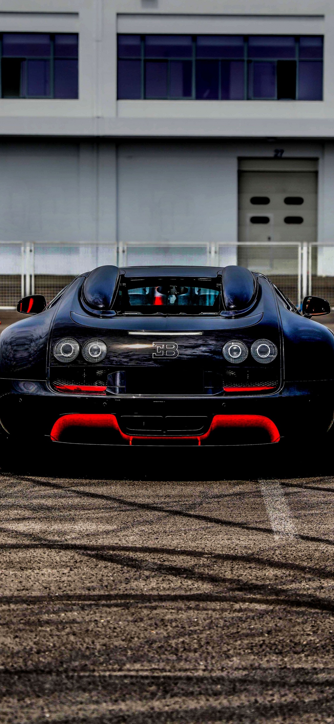 Black Porsche 911 on Road. Wallpaper in 1125x2436 Resolution