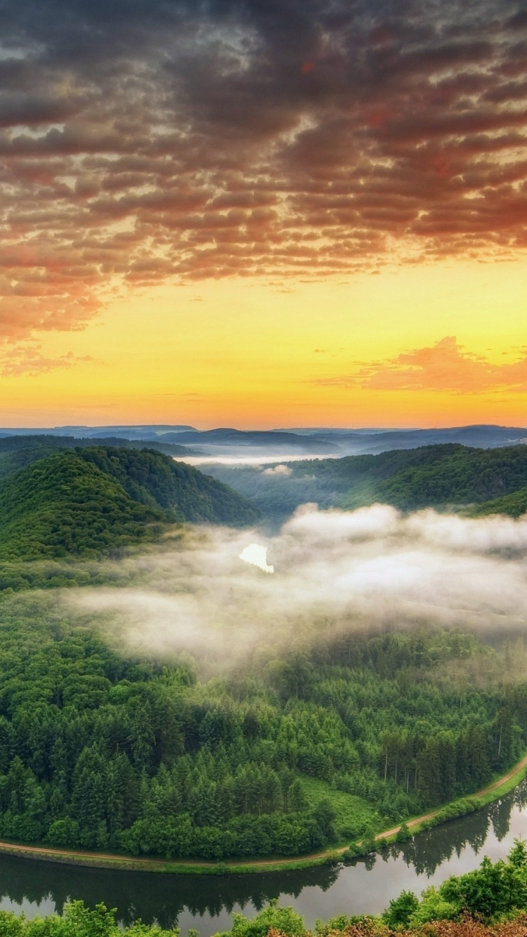 Green Trees and Body of Water Under Cloudy Sky During Daytime. Wallpaper in 750x1334 Resolution