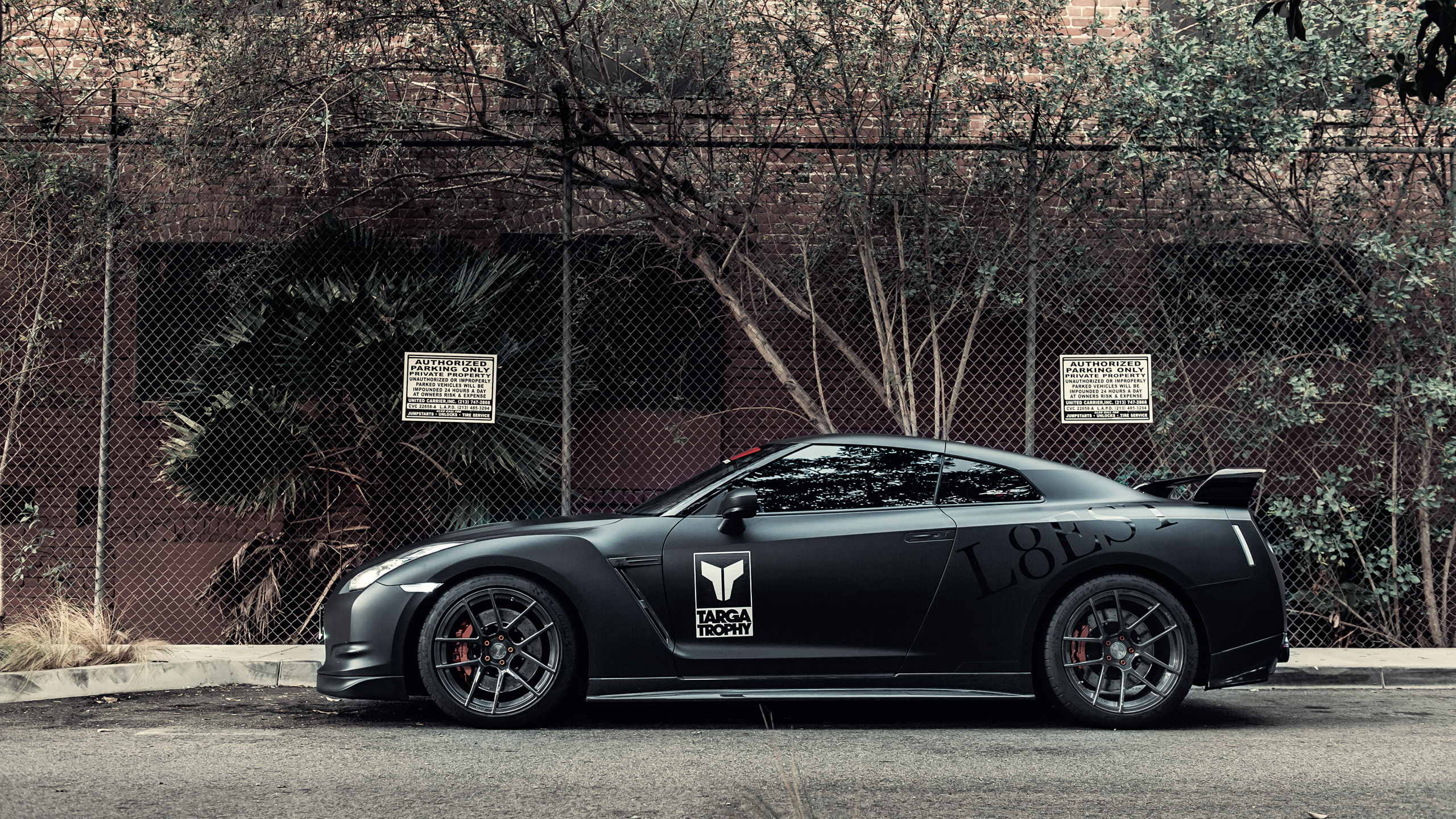 Black Porsche 911 Parked Near Brown Bare Trees During Daytime. Wallpaper in 2560x1440 Resolution